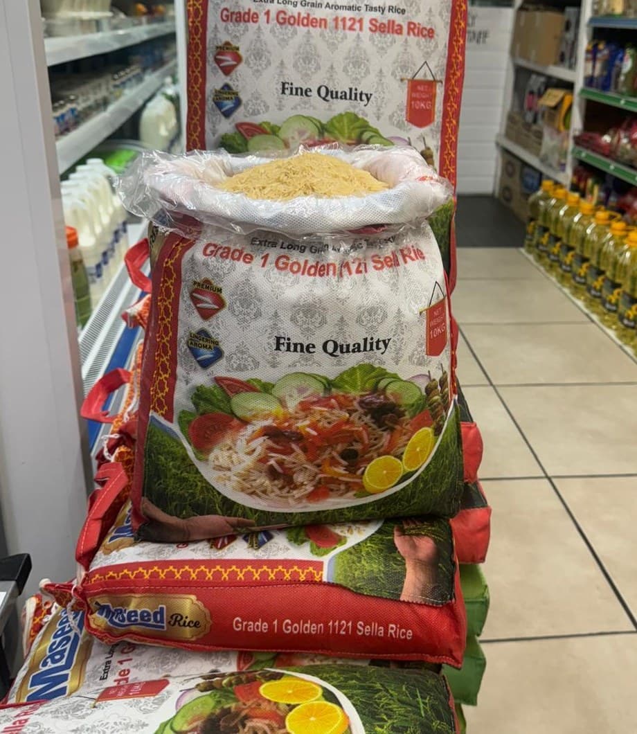 Bags of Maseed rice stacked tightly in the aisle of the Harrow shop.